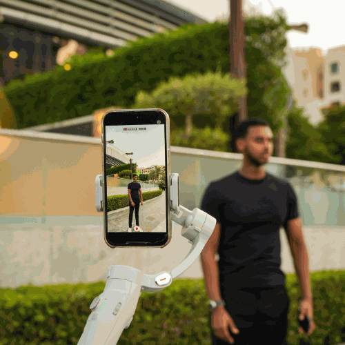 Smartphone on Glide Pro gimbal capturing smooth video in outdoor setting; ideal for creators focused on stable footage.
