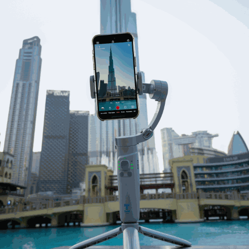 Gimbal Glide Pro stabilizer with smartphone in cityscape setting.